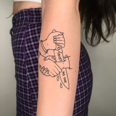 a woman with a tattoo on her arm holding a knife