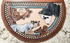 a wall hanging with two dogs on it's side and another dog in the middle