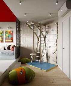 a bedroom with white and red walls, wooden flooring and an indoor play area