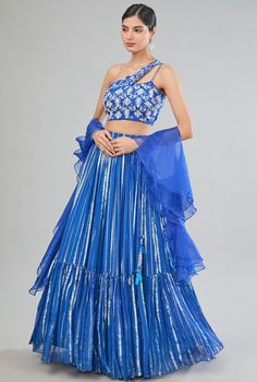 Featuring a blue tiered lehenga in georgette base with zari line detail. It is paired with a one-shoulder organza blouse having hand embroidery and a ruffled dupatta. Style it with statement jewellery and heels for weddings or a sangeet ceremony. Off Shoulder Lehenga, Criss Cross Top, Ivory Blouse, Raw Silk Lehenga, Yellow Lehenga, Organza Blouse, Green Lehenga, Blue Lehenga, Ghagra Choli