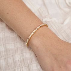 Named after women’s tennis champion Chris Evert, who lost a similar style on the 1987 US Open court, this flexible, close-set diamond bracelet comes adorned with a securely designed clasp that fluidly moves with every gesture (so it’ll stay with you forever). A perennial classic in every era, the single strand looks radiant alone for 5-carats of sparkle and layers with other styles for a more subdued shimmer. Custom sizes are available upon request. Presented in our signature Noémie box. Include Chris Evert, Tennis Champion, Diamond Tennis Bracelet, Us Open, Tennis Bracelet Diamond, 3 Carat, Tennis Bracelet, Quality Diamonds, High Quality Jewelry