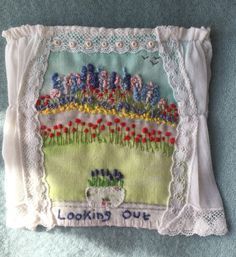 a close up of a piece of cloth with flowers on it and the words looking out