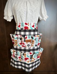 a woman's dress made out of fabric with cats and dogs printed on it