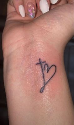 a woman's arm with a small tattoo on the left side of her wrist