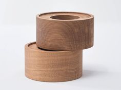 two rolls of wood sitting on top of each other