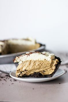 a piece of cake sitting on top of a white plate next to a pie pan