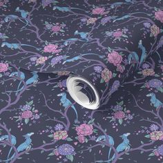 a purple floral wallpaper with birds and flowers on it's side, in front of a dark background