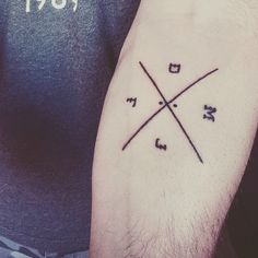 a man with a tattoo on his arm that has an x and y in it