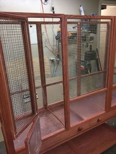 a wooden cabinet with metal mesh doors and shelves on the front, in an office