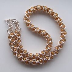 I made this choker using inverted round weave with captive rings.  The rings I made myself using jewellers saw so they close perfectly. The wire has copper base and non-tarnighing coating which will keep this necklace shiny for a long time. I can add extention chain at no extra cost.  I can make this kind of choker from Sterling Silver and/or Gold filled wire (e-mail me for details and price)  Please allow 1 - 2 weeks for making. Handmade Sterling Silver Chain Choker, Metal Chainmail Choker As A Gift, Handmade Metal Chain Necklace With Round Pendant, Silver Chainmail Choker As A Gift, Handmade Round Metal Chain Necklace, Handmade Silver Chain Link Jewelry, Handmade Metal Chain Link Necklace, Jump Ring Link Jewelry As Gift, Round Chainmail Metal Jewelry