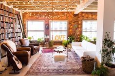 a living room filled with furniture and bookshelves covered in lots of bookcases