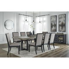 a dining room table and chairs with white walls