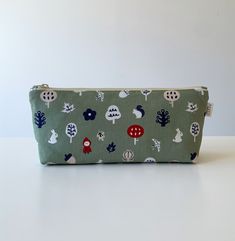 Cute cartoon nature fabric large capacity pencil case, pencil pouch, zipper bag, cosmetic bag, makeup bag Handmade in the UK Size:  - approximately 23cm (L) x 9cm (H) with 5cm base Material:  - 100% cotton (both outer and inner layer) - YKK zipper closure Notes:  - The position of pattern prints may slightly vary due to the different batches of the fabric - The actual color may slightly vary due to lighting effects and monitor settings Cartoon Nature, Nature Fabric, Bag Makeup, Ykk Zipper, Zipper Bag, Pencil Pouch, Bag Handmade, Zipper Bags, Pencil Case