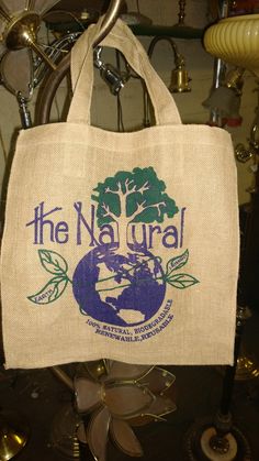 a bag with the logo of the natural is hanging from a hook on a table