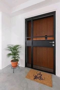 a potted plant sitting in front of a door with the word hello on it