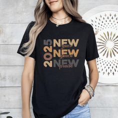 2025 New Year New Grace New Praise T-Shirt, Happy New Years T-Shirt, New Year 2025 TShirt, Funny New Years Tee, Kids 2025 Tee, New Year Tee  🌟Welcome to our collection of stylish and comfortable t-shirts specially designed for fashion enthusiasts!🌟 PRODUCT DETAILS: We take pride in using premium shirts from Bella Canvas and Gildan Soft Style for our prints. *Bella Canvas* - Unisex sizing - Lightweight at 4.2 oz. - Available in various compositions including 100% Combed Cotton, Ring-Spun Cotton, and Polyester blends. *Gildan Soft Style* - Unisex sizing - Available in different fabric compositions, including Ring Cotton, Polyester blends, and 100% Ring Cotton. If you would like either of these brands, please let us know. Otherwise, we will send you the one we have in stock. HOW TO ORDER: ? New Year Bible Verse, Funny New Year, Happy New Years, New Years Shirts, Funny New, Purple T Shirts, Tshirt Funny, Profile Pic, Tshirt Design