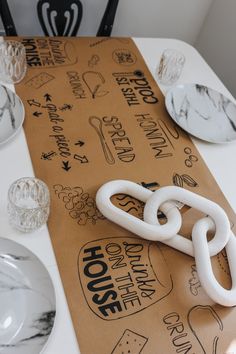 the table is set with plates, silverware and napkins that have been designed to look like chain links