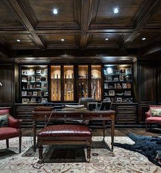 a large room with wooden paneling and leather furniture in the center, along with an area rug on the floor