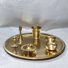 "Thali size - small 7\" Regular 10\" Glass,diyas -approx 2\" Beautiful handcrafted  Includes 8 items altogether  Perfect for all occasions.. Small size -  shiny circle design  Big size design 1 -shiny circle design  Big size design 2 - embedded flower design please note because these are handcrafted , there could be a sight difference in designs.." Gold Ceremonial Sets For Navratri, Gold Tilla Sets For Puja, Gold Cutdana Sets For Puja, Traditional Gold Sets For Diwali, Gold Sets With Traditional Patterns For Diwali, Gold Sets With Traditional Patterns For Puja, Elephant Candle, Diwali Gift Hampers, Ganesha Elephant