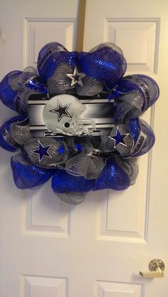 a football wreath on the front door with a helmet hanging from it's side