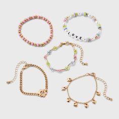 Accessorize your kid's ensemble using this Kids' 5pk Love Bracelet Set by art class™. Featuring a mix of gold bracelets with a secure lobster claw clasp, these hassle-free accessories are perfect for kids on the go. The set of 5 provides versatile options, making it easy to mix and match with a variety of outfits. Elevate your little one’s style with these chic kids love bracelet collection from art class. Art Class™: One-of-a-kind looks for the one and only you Playful Gold Friendship Bracelets With Letter Beads, Target Art, Class Jewelry, Holiday Bracelets, Chic Kids, Puffy Heart Charms, Bracelet Sets, Kids Holiday, Rainbow Bracelet