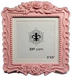 a pink frame with flowers and a fleur de lis design on the front