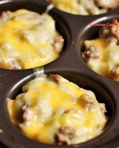 several muffins with cheese and meat in a cupcake tin on a table