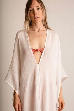 Deep V neck, flowing caftan in a semi sheer, loosely woven cotton gauze with a window pane pattern. Fabric is 100% cotton. This item is one size Bohemian V-neck Blouse For Loungewear, Bohemian V-neck Cover-up For Daywear, Flowy Open Front Top For Beach, Bohemian Cotton Gauze Top For Beach, Chic Blouse With Kimono Sleeves For Beach, Chic Beach Blouse With Kimono Sleeves, Flowy Blouse With Kimono Sleeves For Beach, Summer Cotton Gauze Blouse For Beach, Beach Linen V-neck Blouse