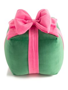 a green bean bag with a pink bow