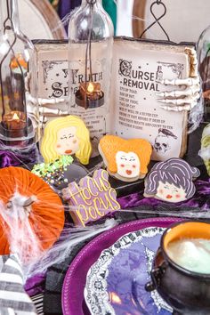 an open book with halloween decorations on it next to some pumpkins and other items