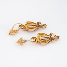 Elegant pair of antique Victorian earrings (circa 1860s to 1870s) crafted in 14k yellow gold.   Old rose cut diamond range in size from 0.01 to 0.30 carats and total an estimated 2 carats (estimated at L-M colour and I2-3 clarity). The charming day & night earrings can be worn as long 2 inch articulated drops, or shorter 3/4 inch drops. The top portion of the earrings are removable. The beautifully designed earrings are set with bright and lively old rose cut diamonds totaling an estimated 2 car Victorian Hallmarked 14k Gold Earrings, Antique Drop Earrings With Historical Design, Antique Gold Earrings With Historical Design, Antique Yellow Gold Ceremonial Earrings, Antique Earrings With Historical Design For Ceremonial Occasions, Victorian Style Ceremonial Earrings For Pierced Ears, 14k Gold Victorian Filigree Earrings, Victorian 14k Gold Filigree Earrings, Victorian Screw Back Earrings For Formal Occasions