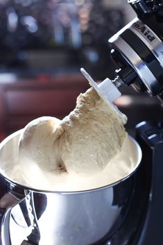 an ice cream scooping in a silver bowl