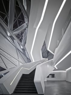 the interior of a modern building with white walls and stairs