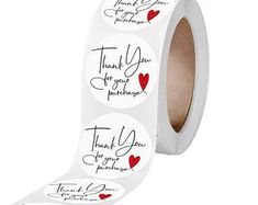 a roll of white thank you stickers with red hearts