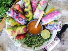 an assortment of food on a plate with dipping sauce