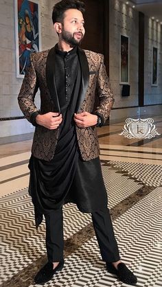 a man in a black suit and tie standing on a tiled floor