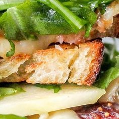 a sandwich with meat, cheese and lettuce