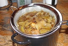 a pot filled with food sitting on top of a counter