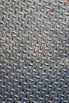 a metal grate with several holes in it