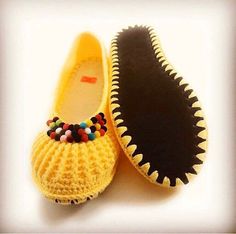 two pairs of slippers with beads on the bottom, one yellow and one black