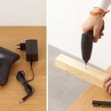 a person is using an electric tool to cut wood and glue it on the table