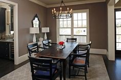 a dining room table with chairs and lamps