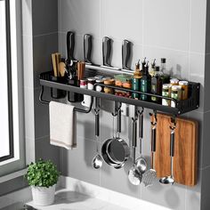 a kitchen with pots, pans and utensils hanging on the wall