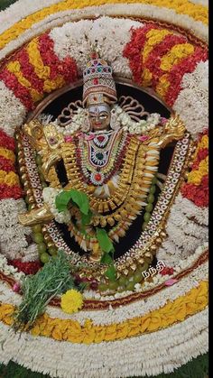 the statue is decorated with flowers and garlands