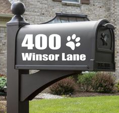 a mailbox with the words winsor lane written on it in front of a house