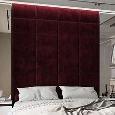 a bedroom with a large red headboard and white bedding