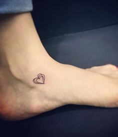 a small heart tattoo on the ankle is seen in this image, it looks like someone has