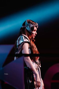 a woman with long red hair wearing a costume