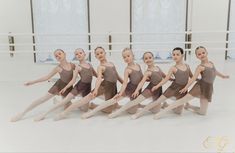 a group of young ballerinas posing for a photo