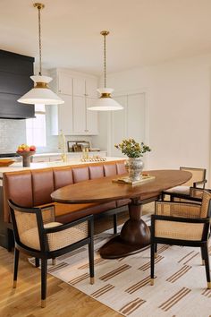 a dining room table with chairs and a bench